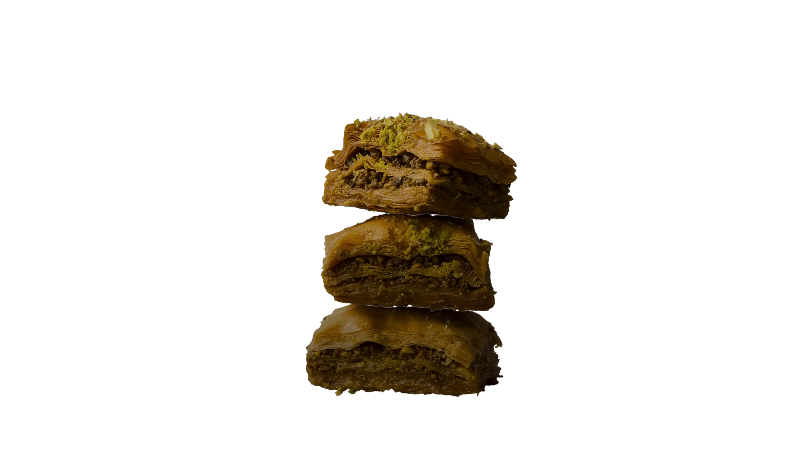 Stack of three pieces of baklava topped with pistachios.
