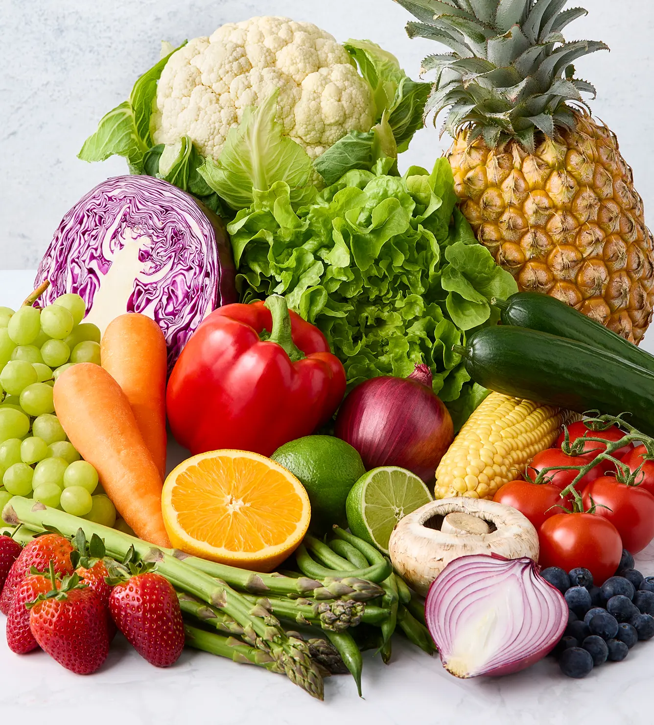 Red and white checkered picnic blanket on green grass.