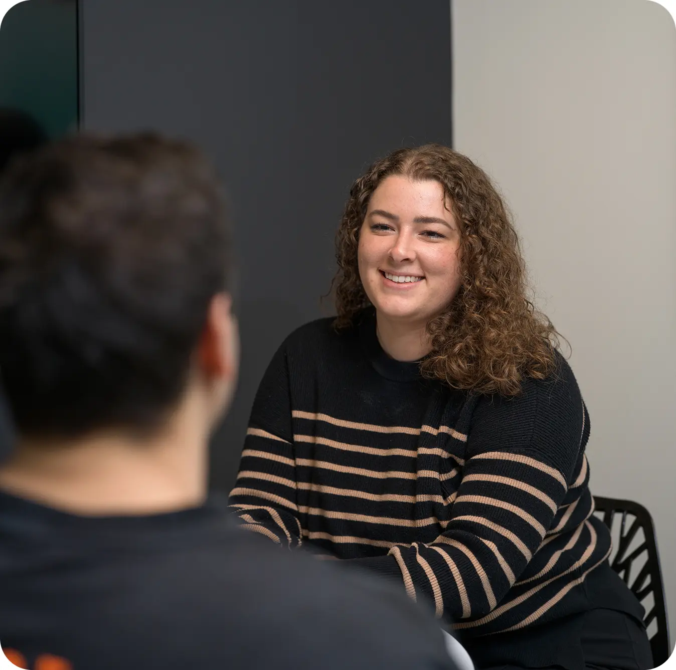 Woman smiling during a testimonial interview.