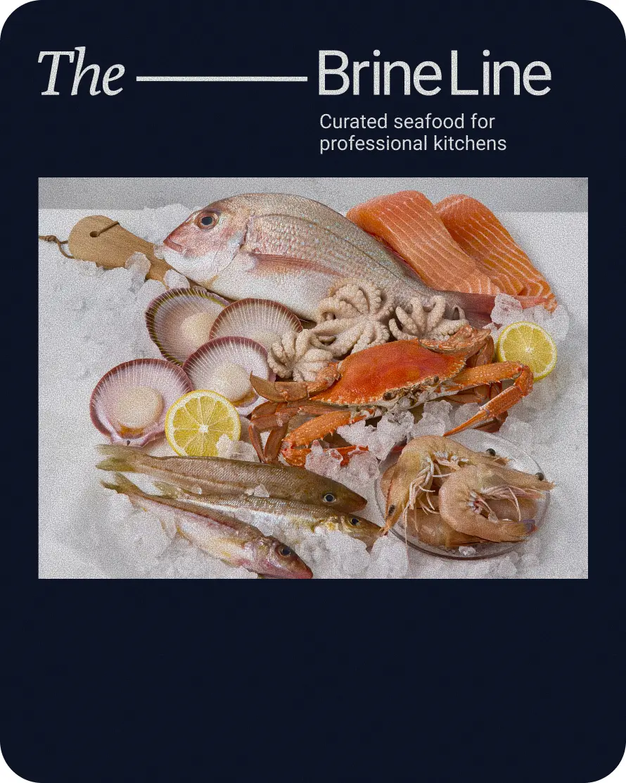 Assorted fresh seafood including fish, crab, shrimp, octopus, and scallops displayed on ice with lemon slices, highlighting The BrineLine's curated offerings for professional kitchens.
