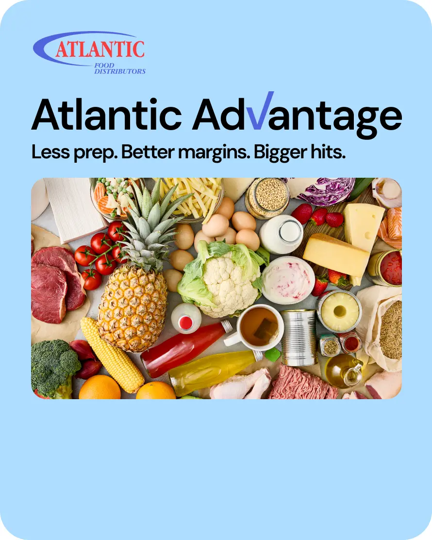 Assorted fresh produce, meats, and dairy products arranged on a table, showcasing Atlantic Food Distributors' Atlantic Advantage program, which focuses on deals tailored for labor, profit, and traffic.