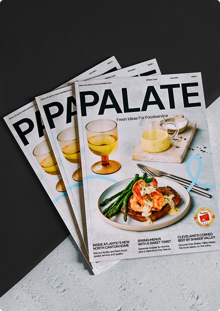Three PALATE magazines displayed on a marble tabletop featuring a foodservice cover design